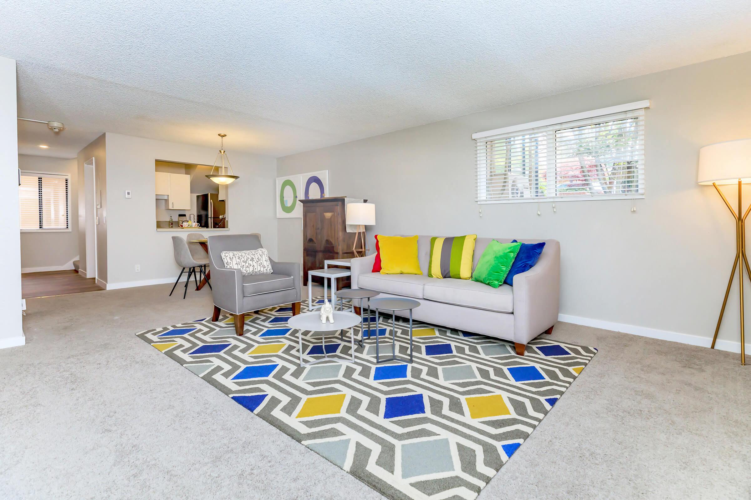 a living room with a couch and a rug