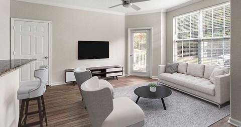 a living room with a couch and chairs and a television