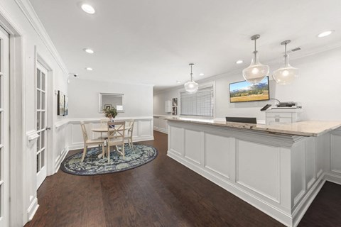 a white kitchen with a table and chairs