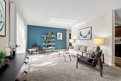 a living room with a blue accent wall and a white couch