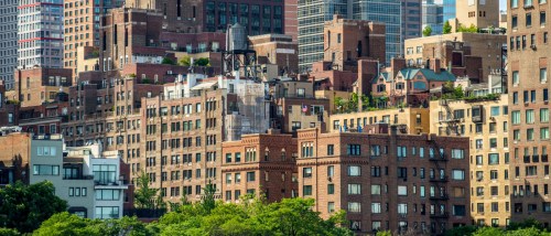 View of Manhattan apartment buildings, highlighting the variety of rental options and the importance of asking key questions before signing a lease.