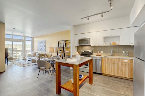 a kitchen and living room with a table
