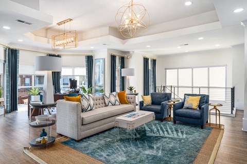 a living room with couches and chairs and a rug