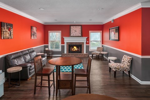 a living room with tables and chairs and a fireplace