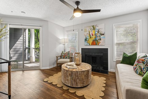A living room with a fireplace and a painting on the wall at Elme Druid Hills, Atlanta, Georgia