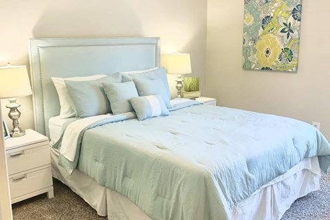 a bedroom with model furnishings at Hills at Hoover 35216