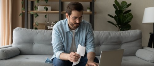 A person carefully checking that they’re not making any mistakes on their rental application form.