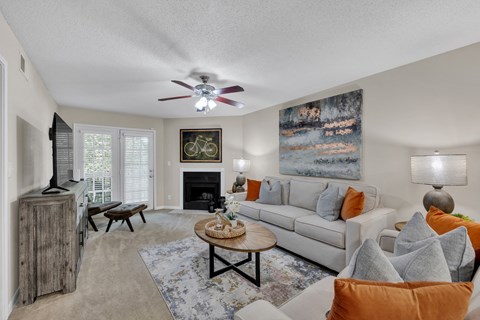 a living room with a couch and a ceiling fan