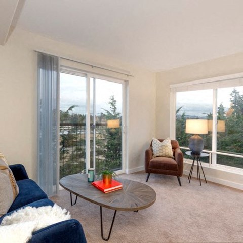 a living room with a couch and a chair and a table