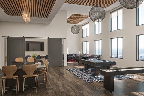 a large living room with a pool table and a television