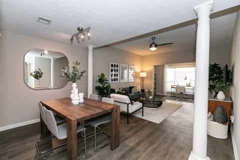 a dining room and living room with a table and chairs at Willowest in Collier Hills, Georgia